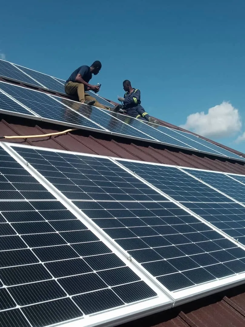 Two Deep Solar installers fixing solar panels on a tiled roof
